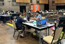 2024 North American Scrabble Championship: Final | USA’s Joshua Winner; Pak’s Waseem Runner-up Players at the 2024 North American Scrabble Championship in a large hall, seated around tables with Scrabble boards and laptops